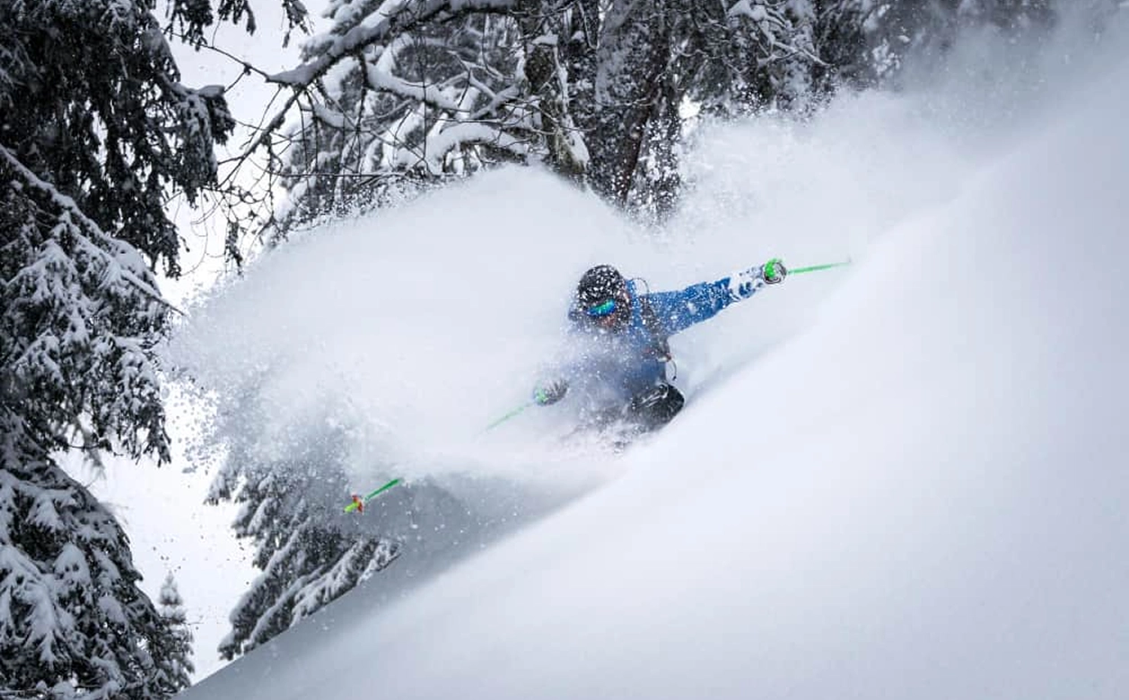A Skier Descends A Snow Covered Slope