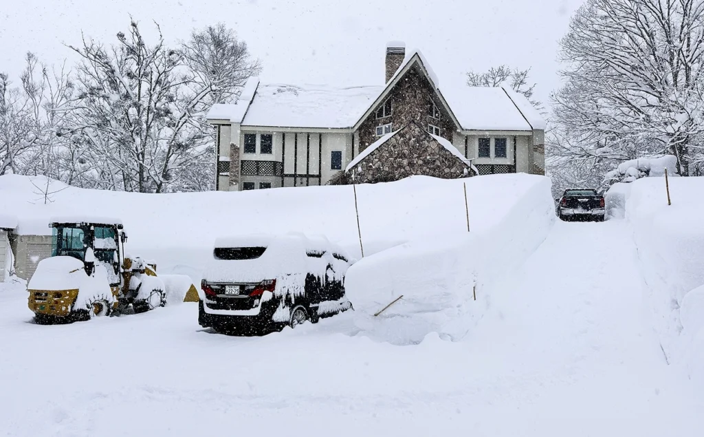 A Snow Covered Driveway Leading To A House