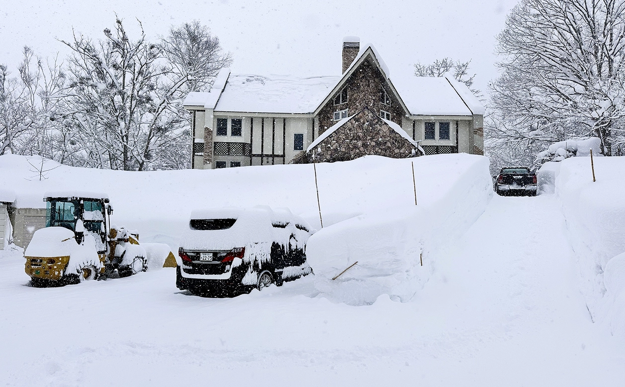 A Snow Covered Driveway Leading To A House
